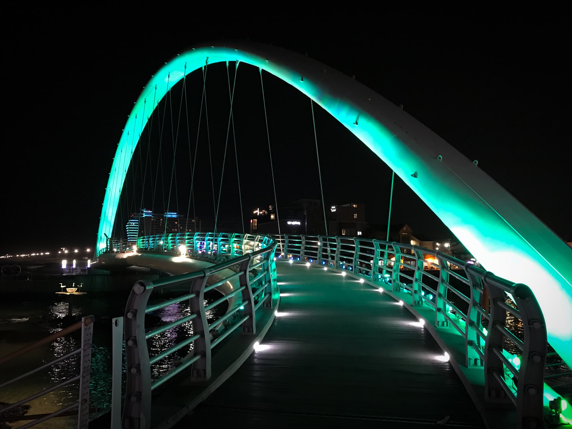 Green illuminated Gangmun Sotdae Bridge at night stock