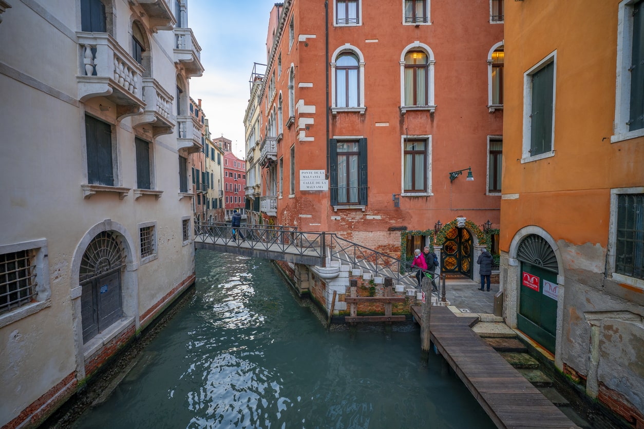 Streets of Venice, water canals and boats moored at the houses