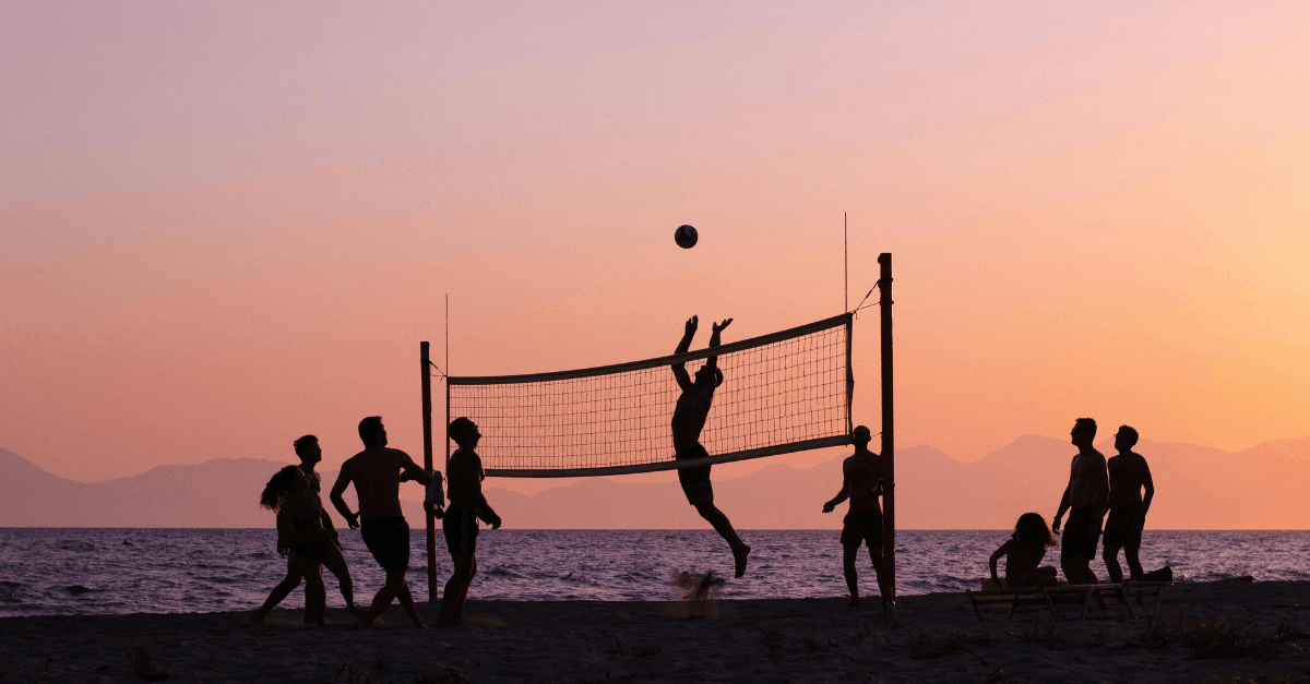 Silhouette of People Playing Volleyball on the Beach During Sunset